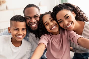 A family smiling together at home